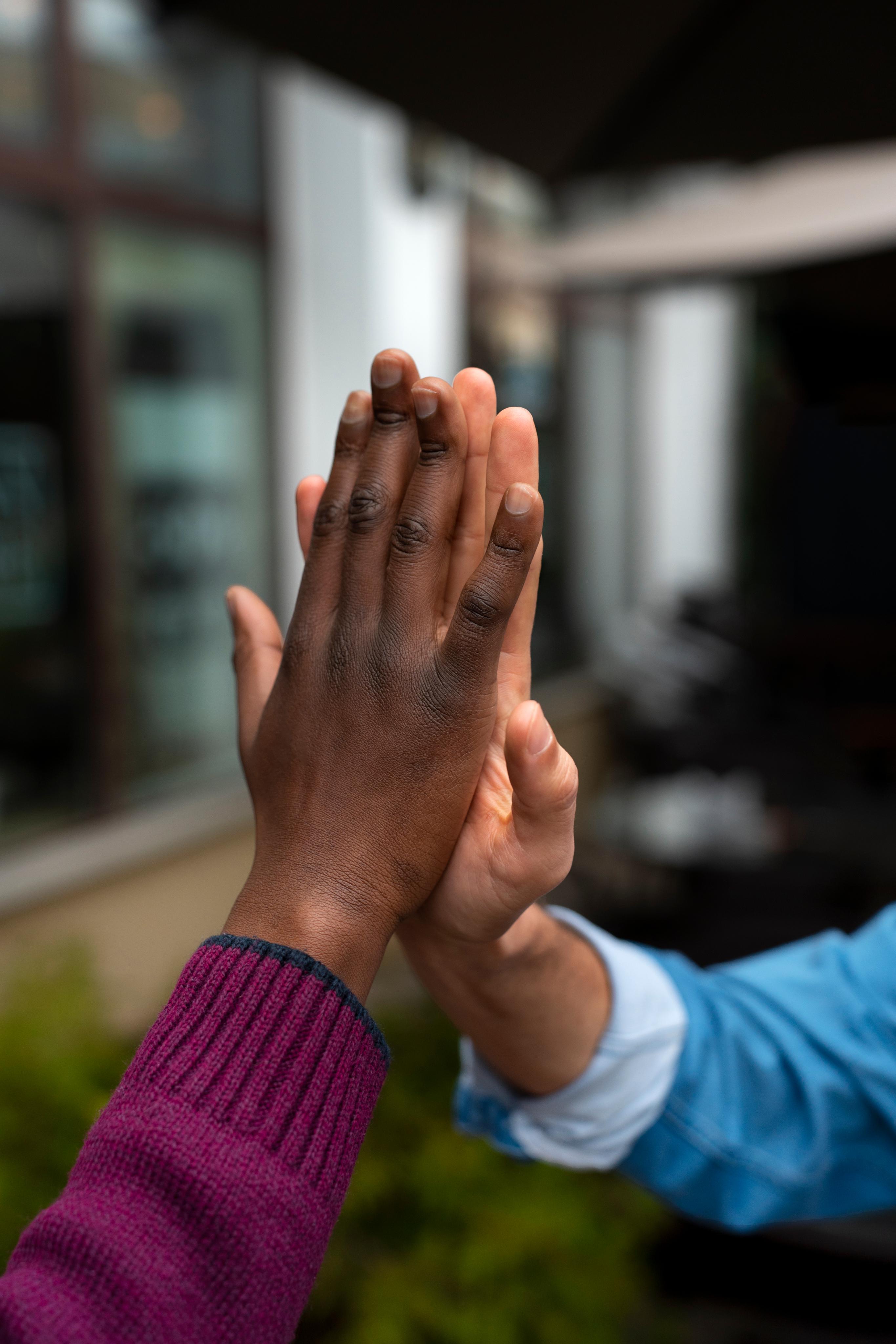Two people giving a high five
